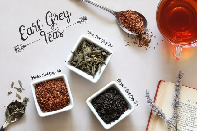 Different types of earl grey tea laying out in ceramic containers, loose-leaf brews