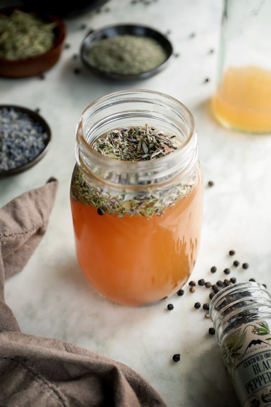 Four Thieves vinegar is a historic concoction using vinegar and aromatic spices and herbs to create a tonic ripe with wellness qualities. Herbs like lavender, black pepper, sage, rosemary, and thyme all make up the formula. 