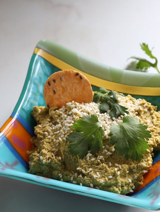 Vegan Carrot Cashew Dip in bowl with sesame seeds and cilantro sprinkled on top
