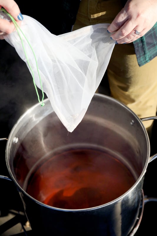 Pot of hot steaming liquid and a filtering bag