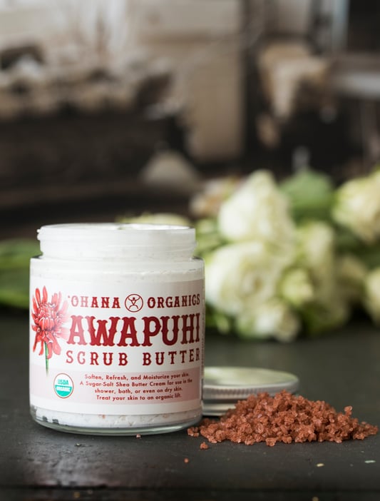 Awapuhi Scrub Butter from Ohana Organics sitting next to pile of red alea salt