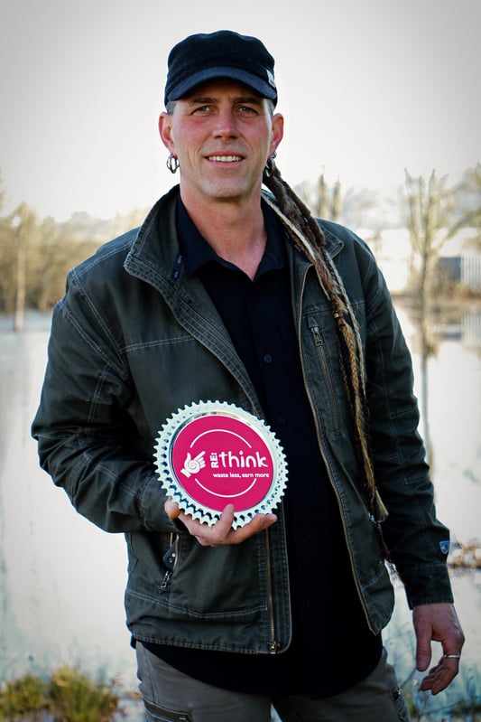 Co-owner of Mountain Rose Herbs, Shawn Donnille, holds Mountain Rose Herbs' certification as a RE:think business from BRING recycling, a local recycling program for tools, building materials, and other goods.