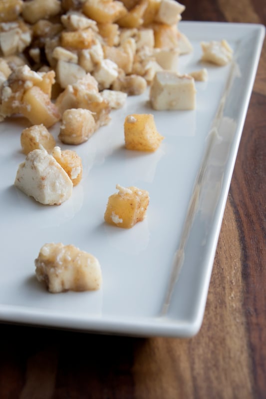 Small pieces of seasoned apples and tofu presented on white plate