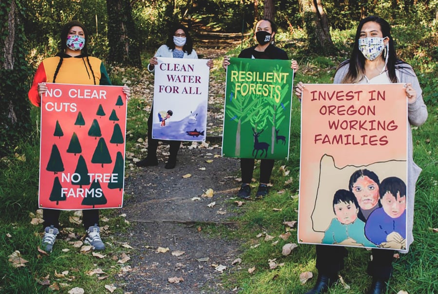 people holding signs in the forest