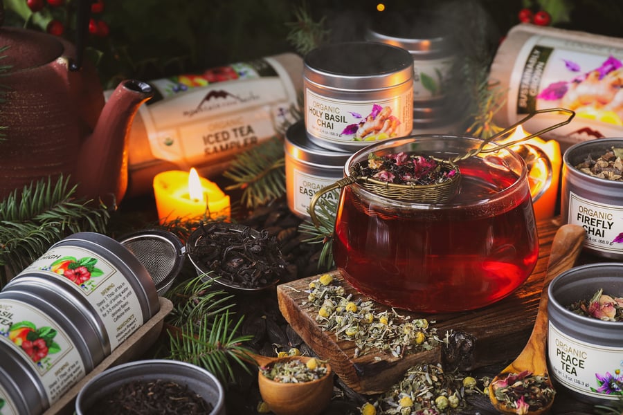 A mug of freshly brewed tea surrounded by tea samplers