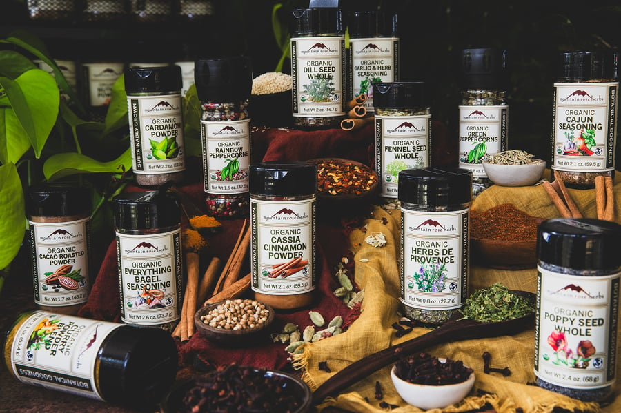 An array of spices and spice blends sit on a kitchen counter