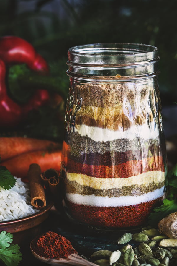 The spices used to create the bebere spice blend stacked up in a jar