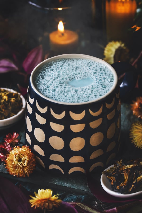 Warm butterfly pea flower moon milk in a mug