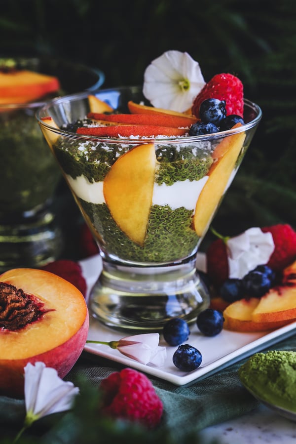 Matcha Chia Pudding in a glass dish with fruit and yogurt