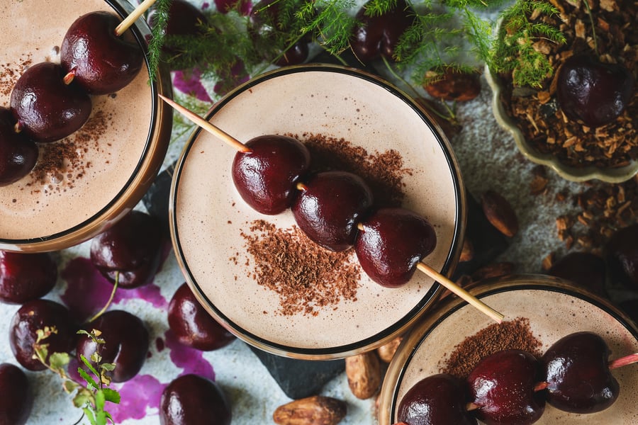 An overhead shot of chocolate mocktini's with fresh cherry garnishes and chocolate shavings