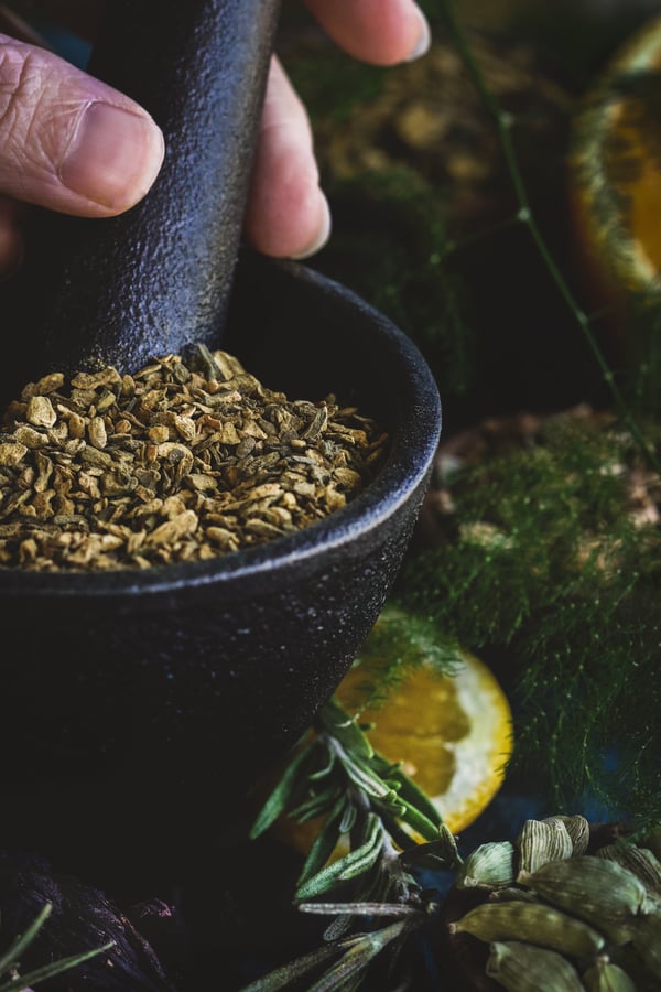 Grinding herbs in a mortar with a pestle
