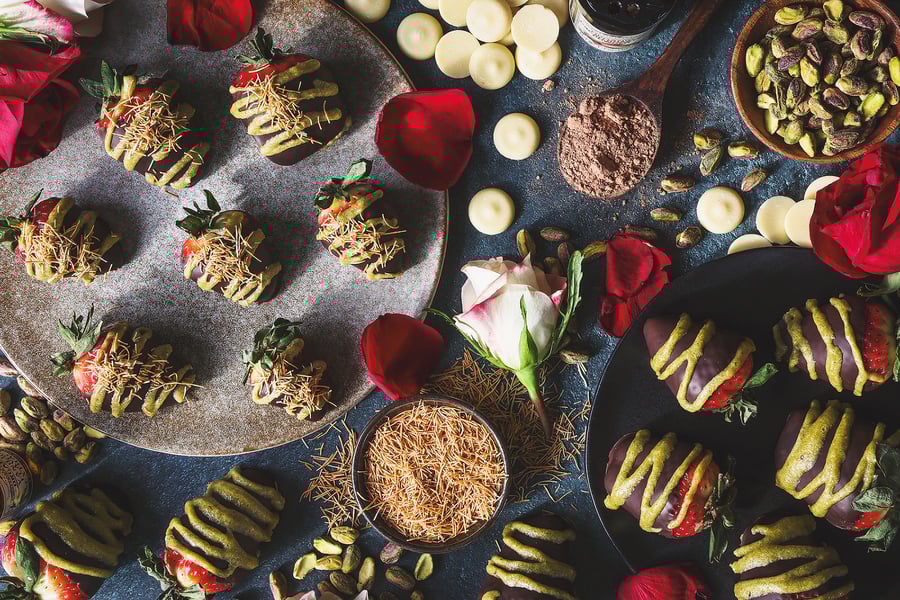 An overhead photo of dubai choclate covered strawberries with ingredients around them