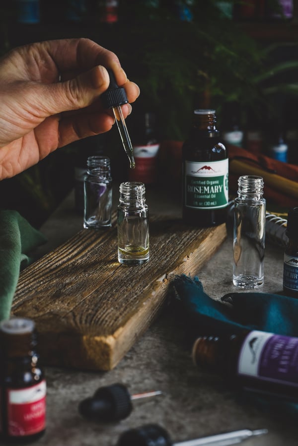 Empty blending bottles and rosemary essential oil ready for a new blend.