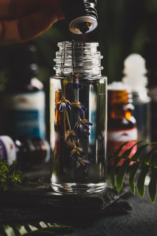 Dripping oil into a roll on oil bottle. 