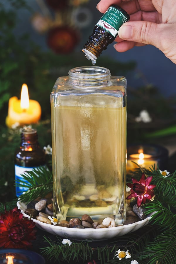 Myrtle essential oil being dripped into castille soap