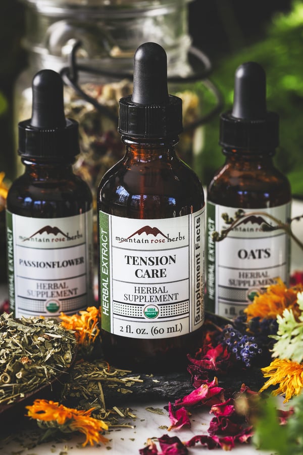 A bottle of tension care extract with passionflower and oats bottles in background