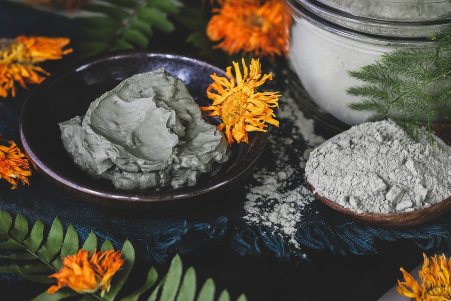 Hydrated french green clay sits beside a spoonful of dry