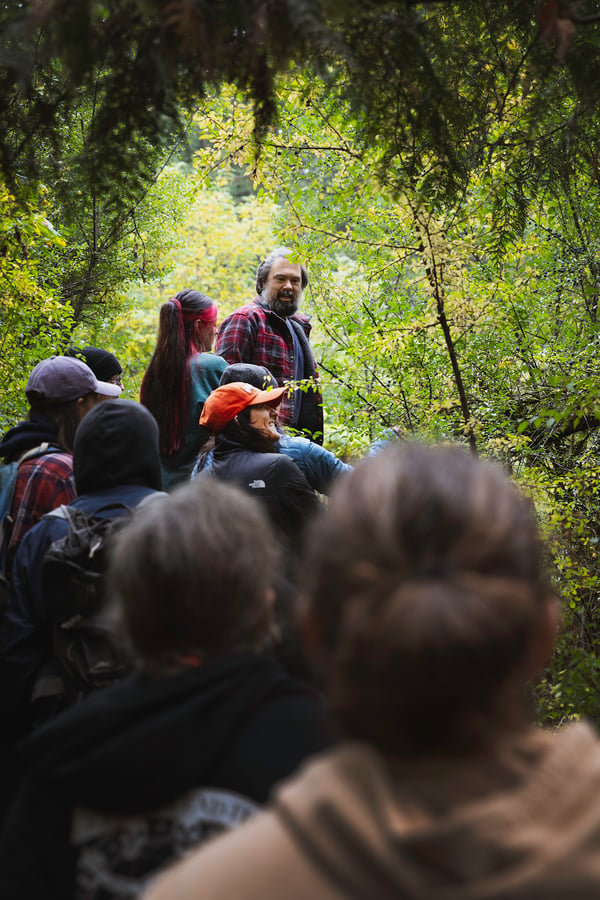 Members of green team are led through the woods as part of a presentation