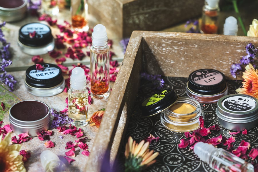 An assorment of herbal adornment products out on a dressing table