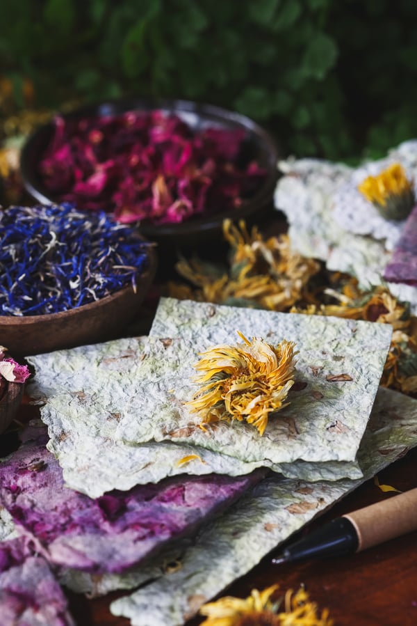A close up photo of herbal paper with a pen nearby for writing