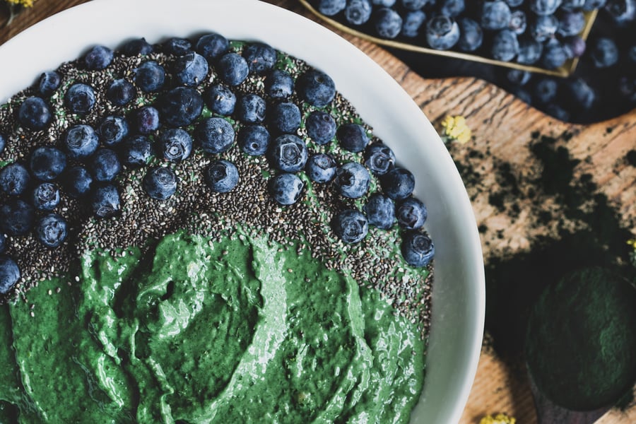 A delicious chlorella smoothie bowl topped with berries