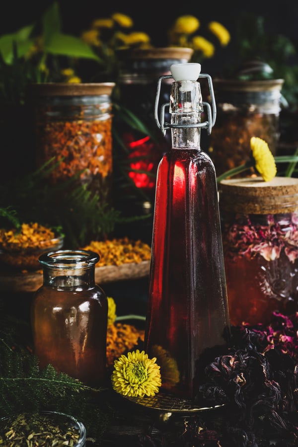 Infused simple syrups sit among herbs