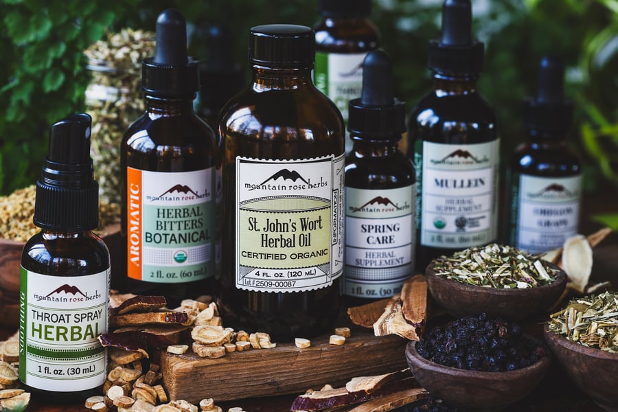 An assortment of dried herbs, extracts, herbal oils, and bitters to support wellness