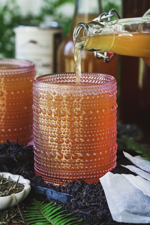 Homemade kombucha being poured into a glass