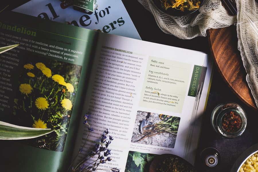 An herbal book lays open mid reading