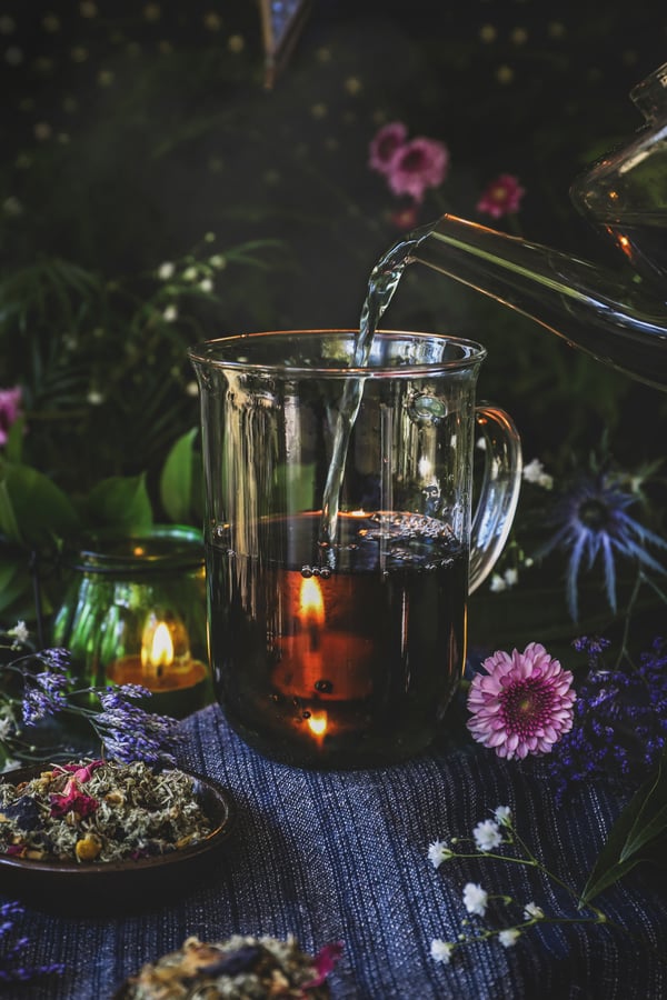 Warm lucid dreaming tea is poured into a glass mug