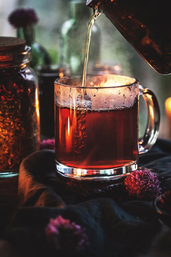 Hot tea being poured into a mug