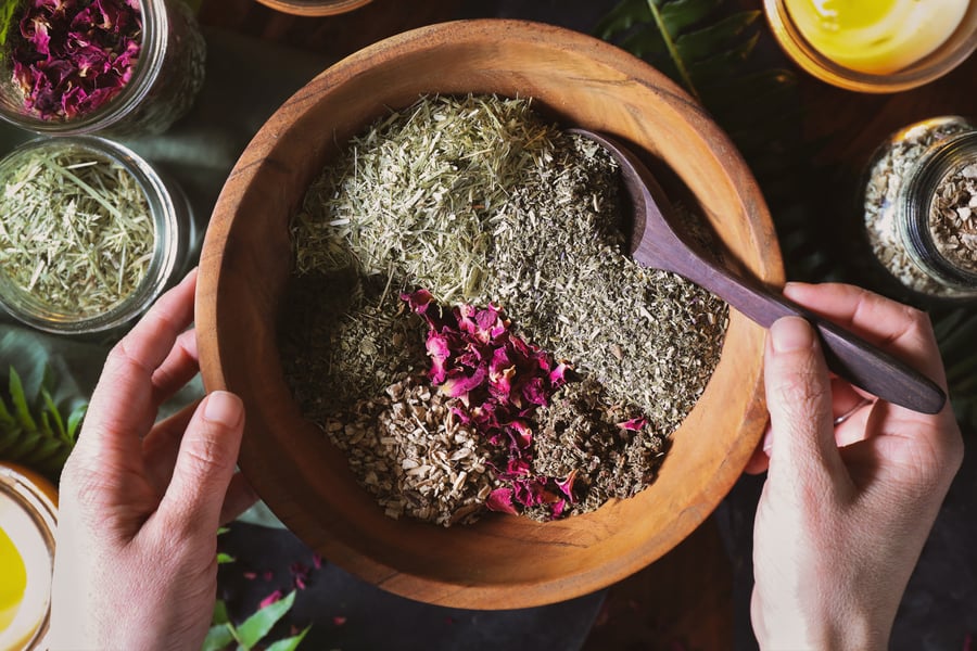 Herbs for menstruation support tea blend sit in bowl