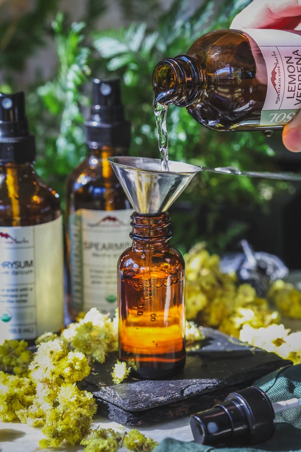 Hydrosol being poured into small bottle for blending