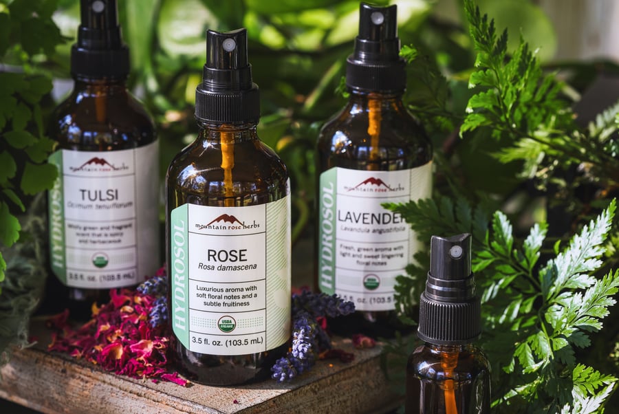 Mountain Rose Herbs Hydrsosols used for self love toner recipe sitting out with dried red rose and lavender. 