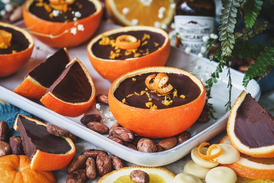 Chocolate orange cups on a serving tray with ingredients around them