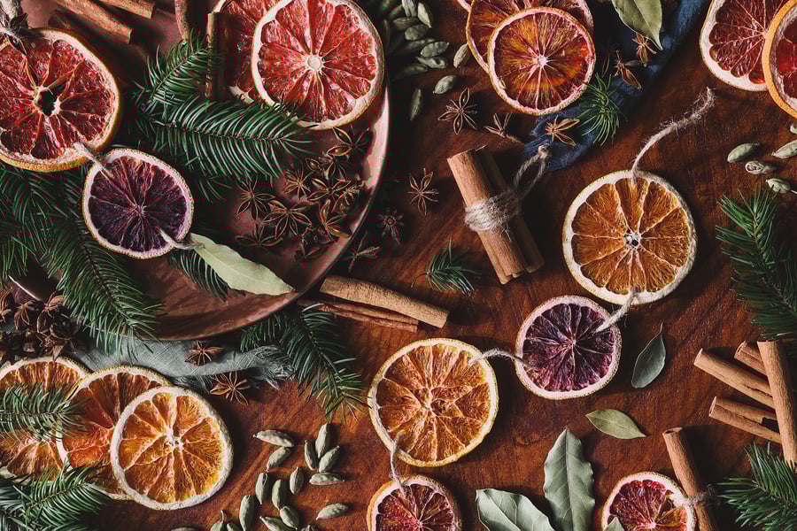An overhead view of dried oranges and herbs for garland crafting