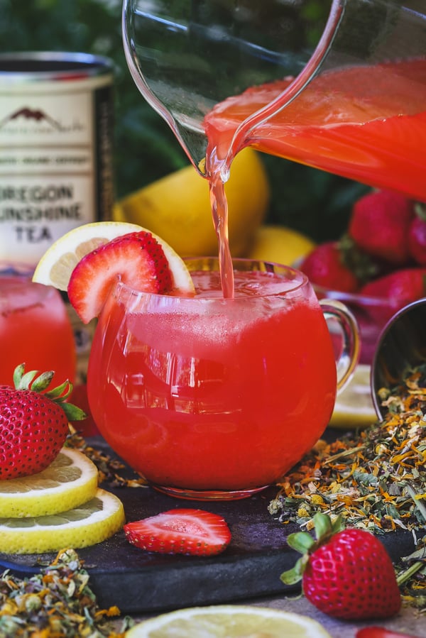 Oregon sunshine strawberry lemonade being poured into a glass mug