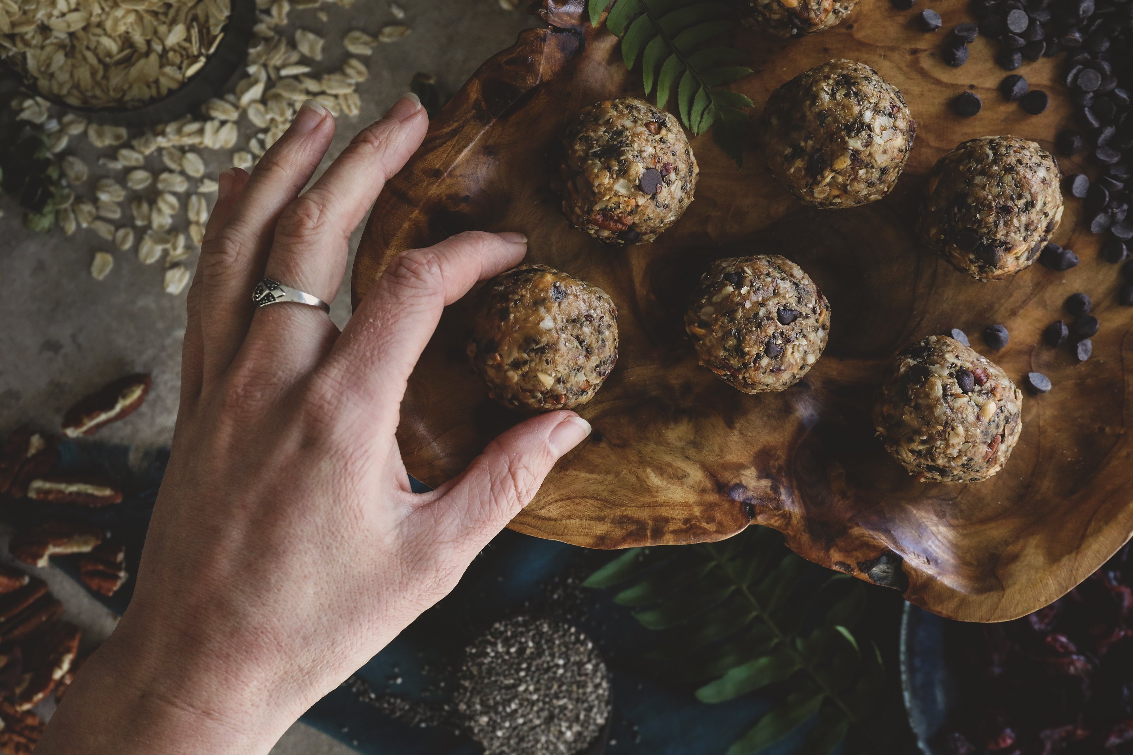 Hand grabbing snack balls with chia seeds