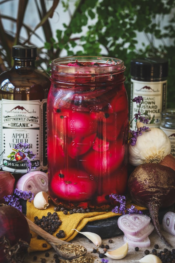 A jar with eggs pickling inside of it