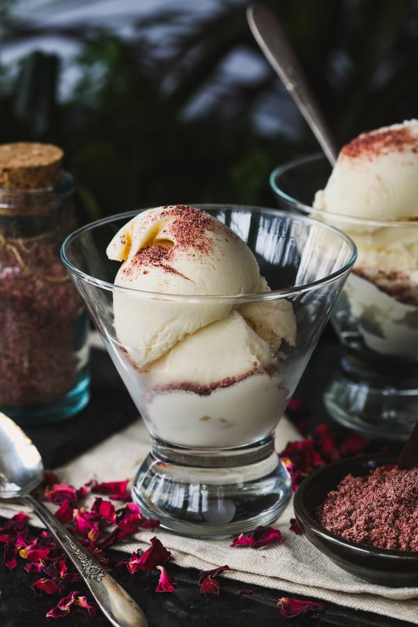 A scoop of vanilla ice cream sprinkled with red floral salt