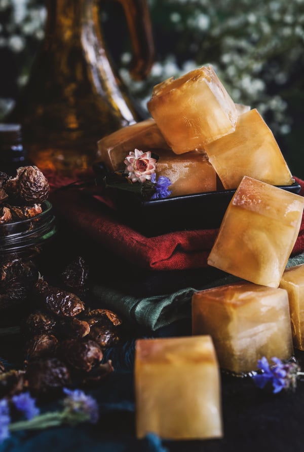 Soap nut detergent cubes sit on a pile of laundry