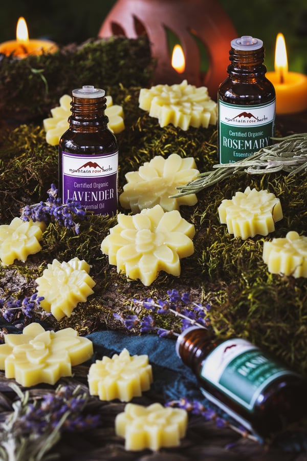 Wax melts and essential oils are scattered on a surface