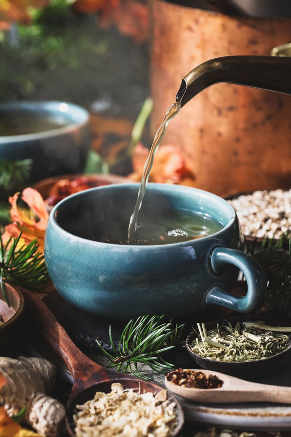 Hot tea being poured into mug