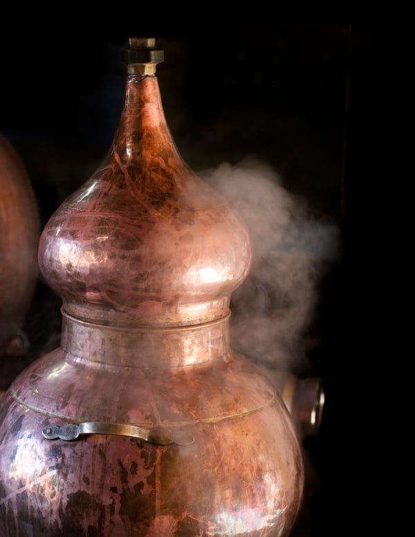 A copper still steams 