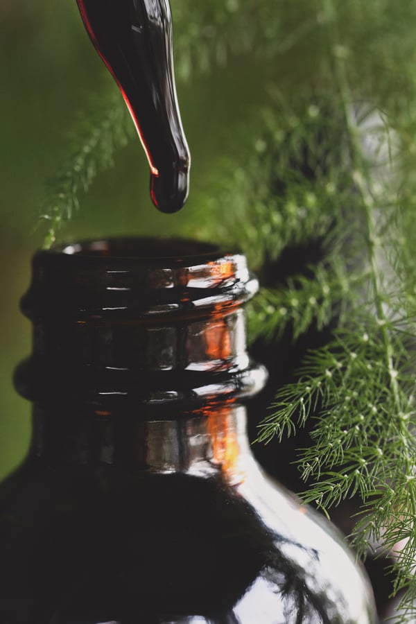 A close up photo of a dropper with extract dripping out of it