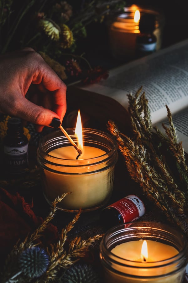 A homemade candle is being lit