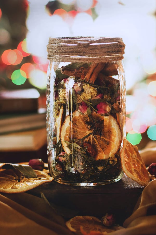 A jar of herbal potpourri sits on a counter
