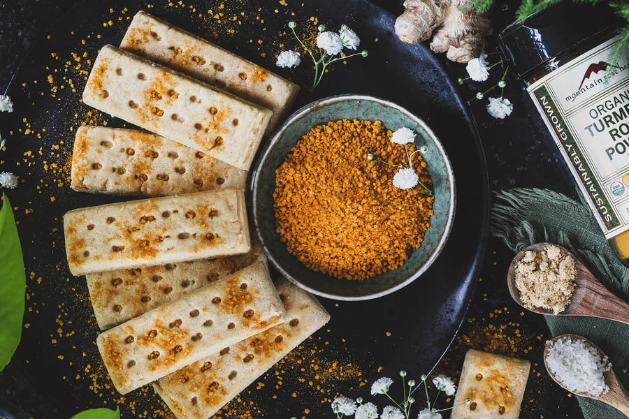 A plate of cookies sprinkled with orange salt sits out on a table