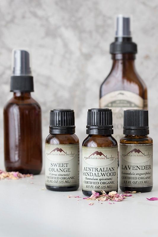 Display of essential oils including sweet orange, sandalwood, and lavender