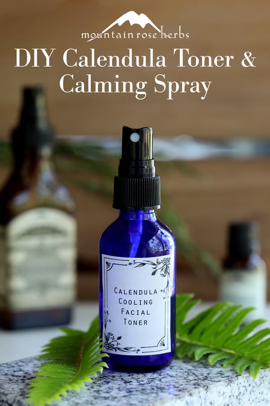 Pinterest link to Mountain Rose Herbs. Cobalt spray bottle with calendula facial toner with fern and marble